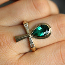 Ankh emerald and baguette diamond ring, showcasing natural gems and brilliant cut.