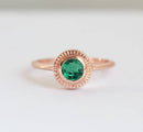 Emerald solitaire ring with 5mm round green gem on 1.6mm band.