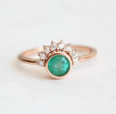 Elegant 0.4ct Emerald ring with diamond halo in 18k gold band.