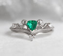 Vintage emerald and diamond ring set in 14k or 18k gold, featuring a green trillion emerald and sparkling white diamonds.