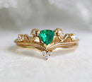 Vintage emerald and diamond ring set in 14k or 18k gold, featuring a green gem.