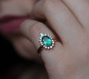 Close-up of Oval Emerald Ring with oval cut Emerald, Pear Diamonds, and Round Diamonds.