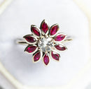Round white sapphire floral ring with side rubies
