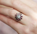 Round white sapphire floral ring with side rubies