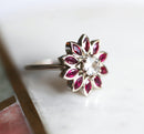 Round white sapphire floral ring with side rubies