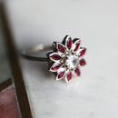 Round white sapphire floral ring with side rubies