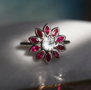 Round white sapphire floral ring with side rubies