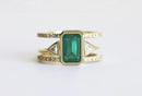Emerald ring set with Diamond pave, open band, and custom gemstone options.
