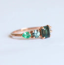 Emerald-cut sapphire cluster ring with emeralds and diamonds
