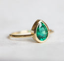 Sophisticated Pear Emerald Ring, featuring a green pear-cut Emerald stone. Elegant solitaire design.