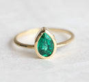 Sophisticated  Pear Emerald Ring, featuring a gold band with a stunning green gem.
