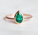 Sophisticated Customizable Pear Emerald Ring with pear-cut green gemstone solitaire design. Crafted in 14k/18k gold or platinum.