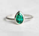 Sophisticated Pear Emerald Ring with pear-cut green Emerald solitaire design. Finely crafted in 14k/18k Gold or platinum.
