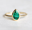 Sophisticated Pear Emerald Ring, featuring a pear-cut green Emerald stone. Solitaire design in 14k or 18k gold.