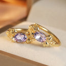 Boucles oreilles dorées violettes