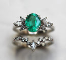 Oval Emerald Ring Set: Oval-cut Emerald with White Diamonds on marquise band.